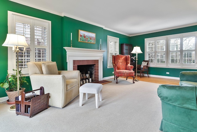 living area with baseboards, ornamental molding, and a brick fireplace