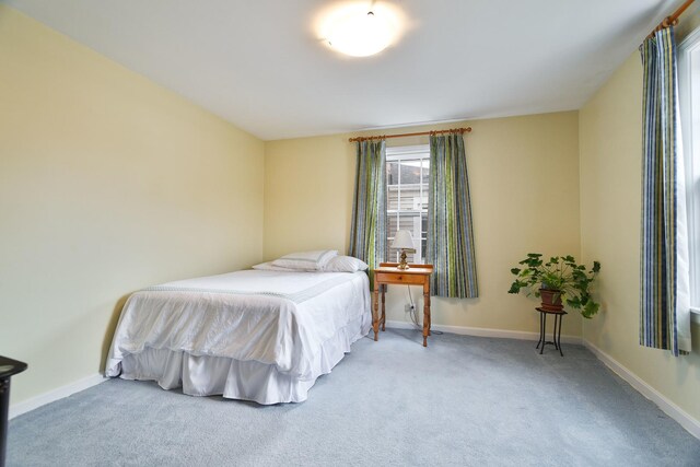 bedroom featuring carpet floors and baseboards