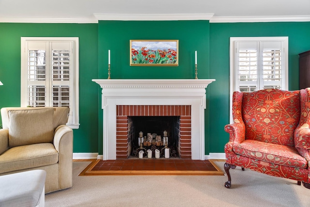 living area featuring ornamental molding, carpet flooring, baseboards, and a fireplace