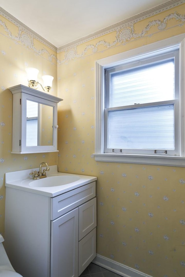 bathroom featuring wallpapered walls and vanity