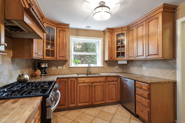 kitchen featuring gas stove, a sink, dishwasher, and brown cabinetry