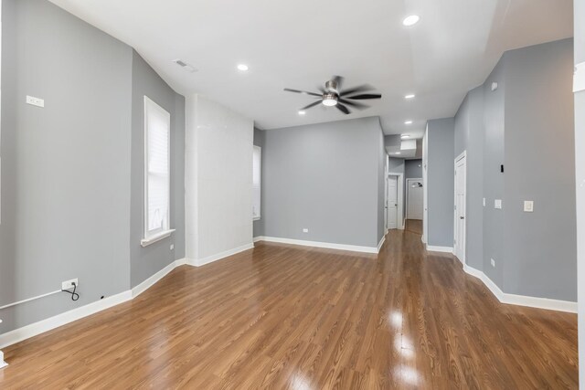spare room featuring a ceiling fan, light wood-style floors, baseboards, visible vents, and recessed lighting