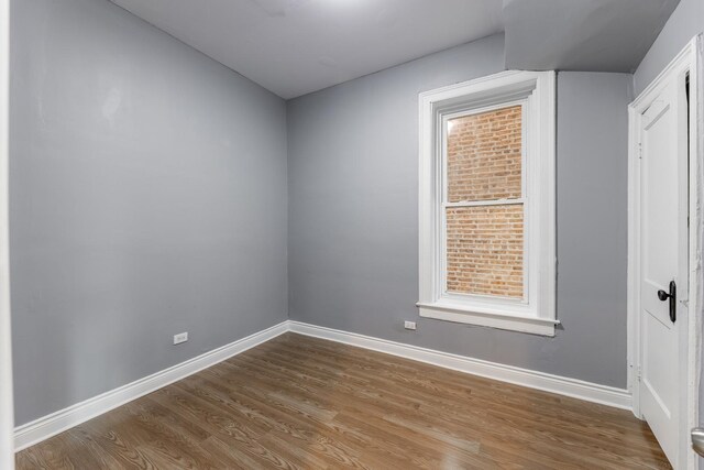 unfurnished room with wood finished floors and baseboards