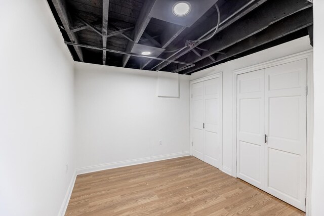 finished basement with light wood-style flooring and baseboards