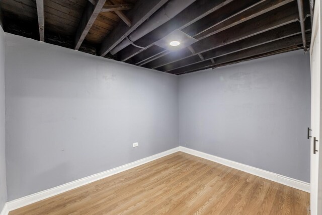 finished basement featuring wood finished floors and baseboards