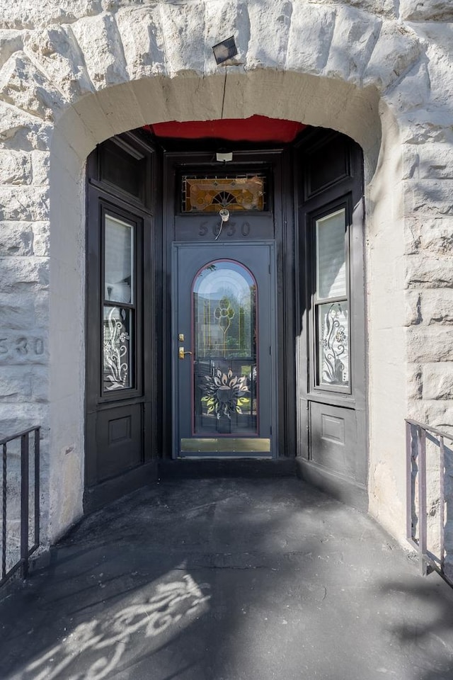 entrance to property featuring stone siding