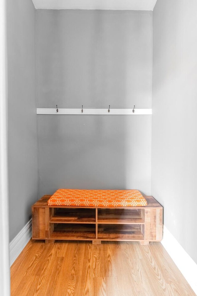 mudroom featuring baseboards and wood finished floors