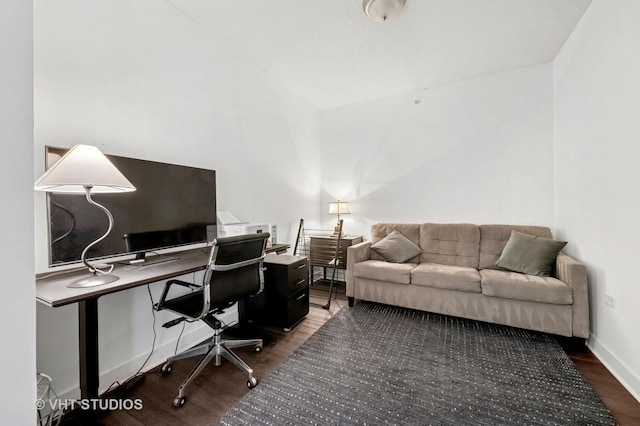 office with wood finished floors, lofted ceiling, and baseboards