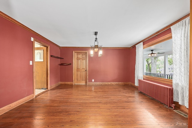 331 E Joliet Hwy, New Lenox, IL 60451 - unfurnished room featuring radiator, wood finished floors, crown molding, baseboards, and a chandelier