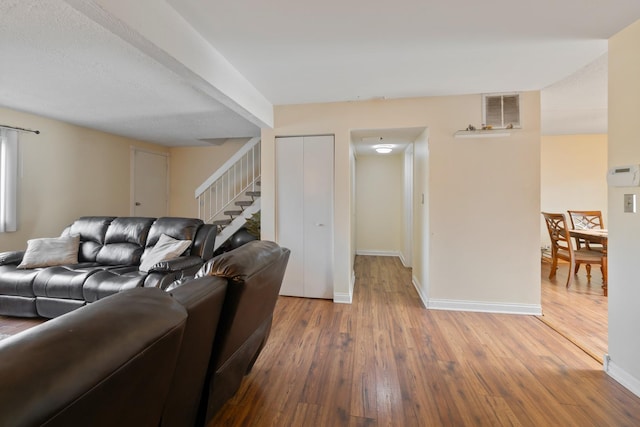 5118 Carol Ln, Gurnee, IL 60031 - living room with baseboards, wood finished floors, visible vents, and stairs