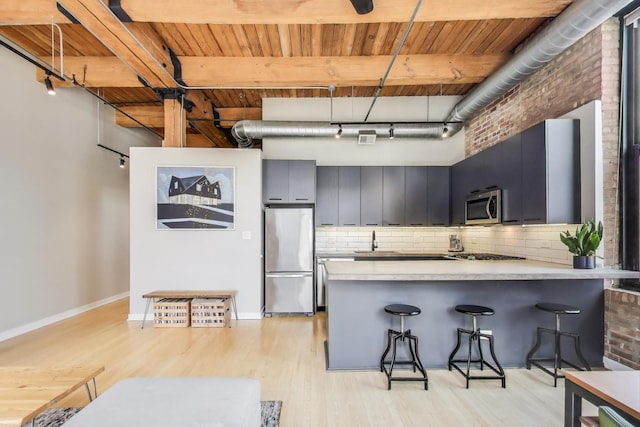kitchen featuring light wood-type flooring, wood ceiling, a peninsula, and stainless steel appliances