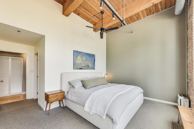carpeted bedroom with wood ceiling, baseboards, beamed ceiling, and a baseboard heating unit