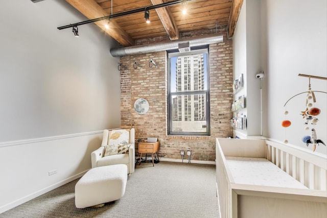 carpeted bedroom with wood ceiling, baseboards, beam ceiling, and brick wall