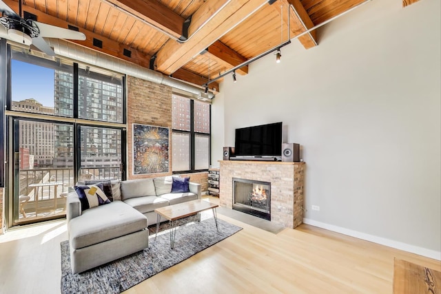 living area featuring rail lighting, wood ceiling, and wood finished floors