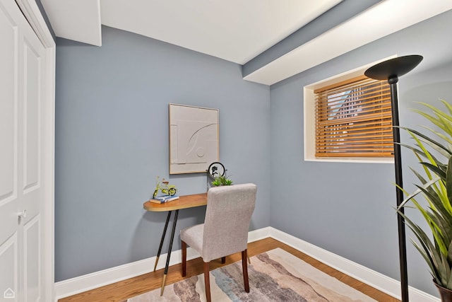 office featuring baseboards and wood finished floors