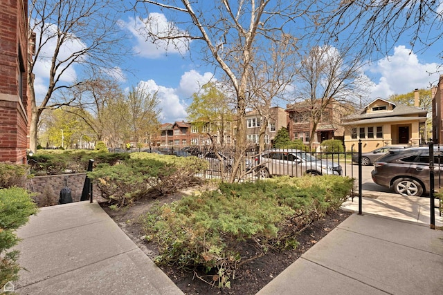 view of yard featuring fence and a residential view
