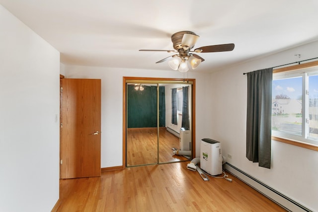 9407 S Roberts Rd Unit 3Se, Hickory Hills, IL 60457 - unfurnished bedroom featuring a closet, baseboard heating, and light wood-type flooring