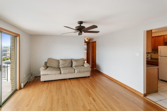 9407 S Roberts Rd Unit 3Se, Hickory Hills, IL 60457 - living room with light wood finished floors, ceiling fan, baseboards, and a baseboard radiator