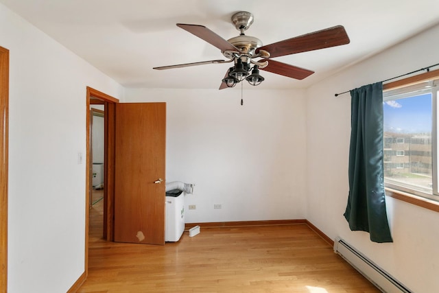 9407 S Roberts Rd Unit 3Se, Hickory Hills, IL 60457 - spare room featuring ceiling fan, baseboards, light wood-style flooring, and a baseboard radiator