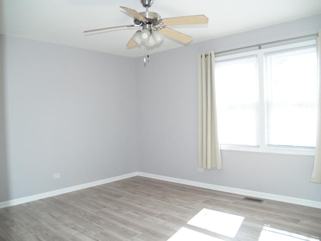 213 Hudson Ct Unit D, Bolingbrook, IL 60440 - empty room featuring light wood finished floors, a ceiling fan, and baseboards