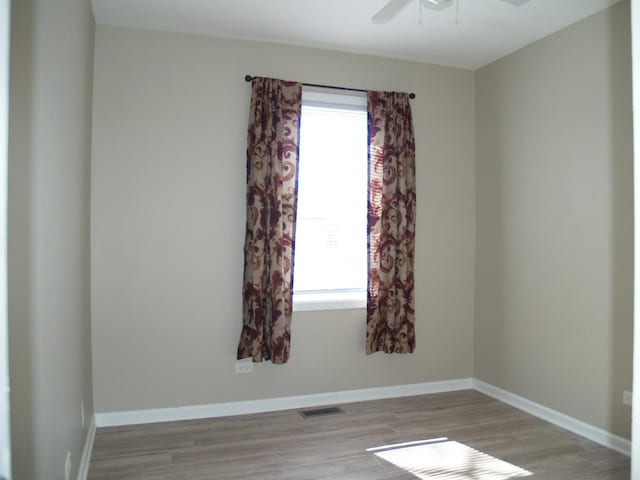 213 Hudson Ct Unit D, Bolingbrook, IL 60440 - spare room featuring light wood finished floors, baseboards, a ceiling fan, and visible vents