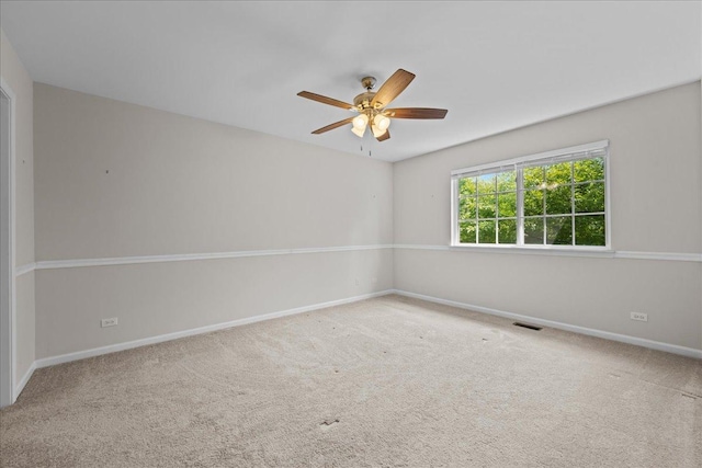 empty room featuring ceiling fan, carpet flooring, and baseboards