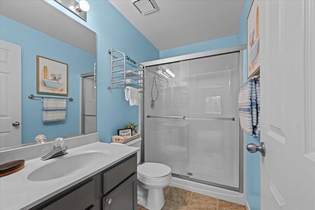 full bathroom with a shower stall, toilet, and vanity