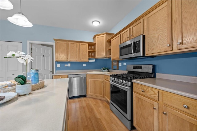 kitchen featuring appliances with stainless steel finishes, open shelves, light countertops, and light wood-style floors