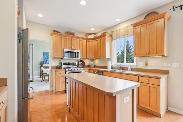 34457 N Bluestem Rd, Round Lake, IL 60073 - kitchen featuring a sink, appliances with stainless steel finishes, light wood-style flooring, and light countertops