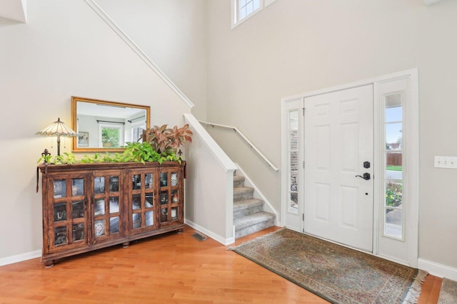 34457 N Bluestem Rd, Round Lake, IL 60073 - foyer entrance with baseboards, a high ceiling, stairs, and wood finished floors