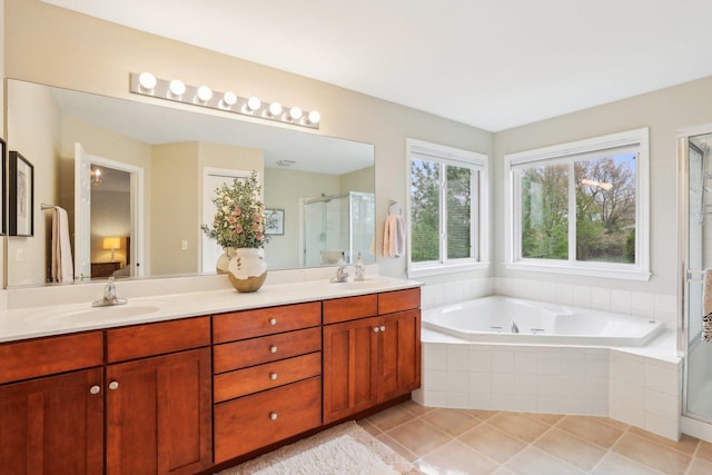 34457 N Bluestem Rd, Round Lake, IL 60073 - full bath featuring double vanity, a bath, tile patterned floors, a shower stall, and a sink