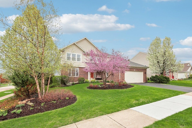 34457 N Bluestem Rd, Round Lake, IL 60073 - traditional home with a garage, driveway, a front lawn, and brick siding