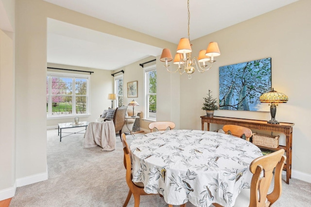 34457 N Bluestem Rd, Round Lake, IL 60073 - dining room featuring carpet flooring, baseboards, and a chandelier