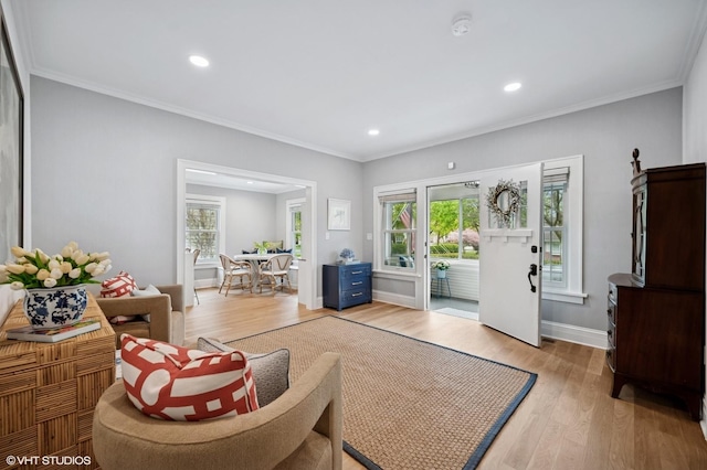 living area featuring light wood finished floors, a wealth of natural light, and recessed lighting