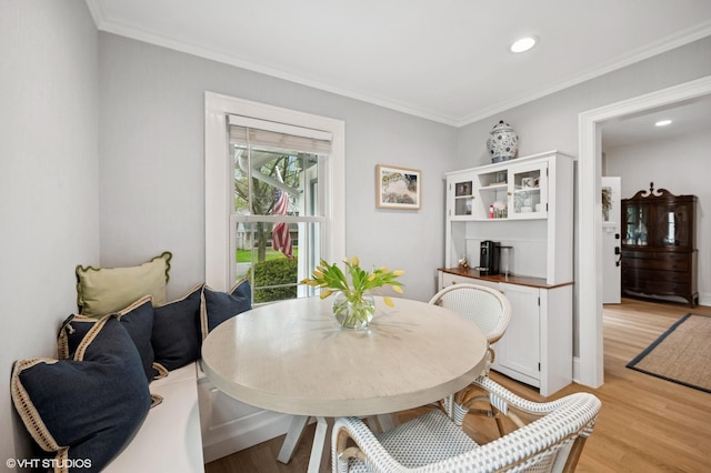 dining room with crown molding, light wood-style floors, and recessed lighting