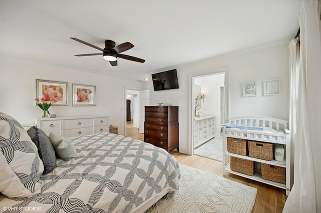 bedroom with ornamental molding, light wood-style flooring, connected bathroom, and ceiling fan