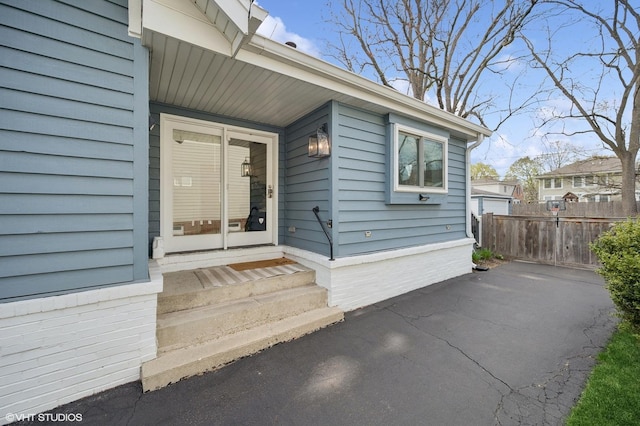 property entrance with a patio area and fence