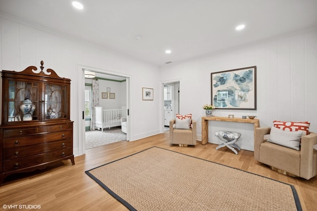 sitting room with recessed lighting, ornamental molding, and light wood-type flooring