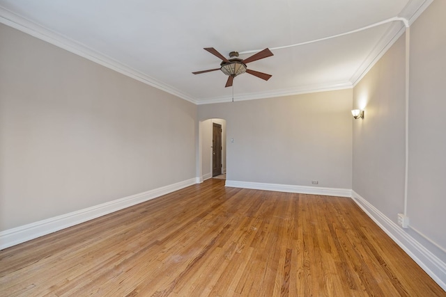 unfurnished room with arched walkways, light wood finished floors, a ceiling fan, and ornamental molding