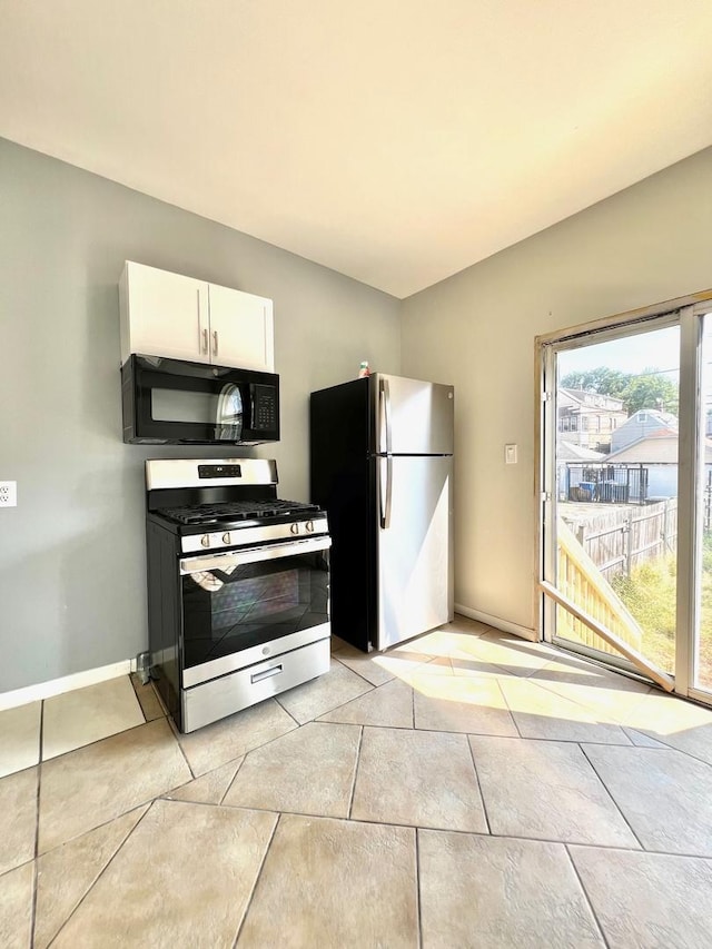 2245 S Homan Ave, Chicago, IL 60623 - kitchen with baseboards, white cabinetry, stainless steel appliances, and light tile patterned floors