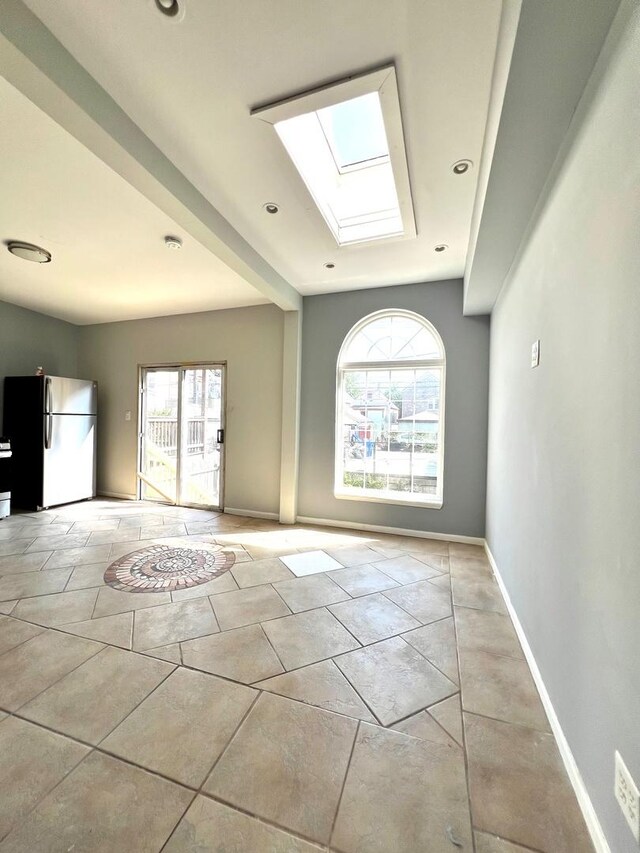 2245 S Homan Ave, Chicago, IL 60623 - spare room featuring plenty of natural light, baseboards, and a skylight