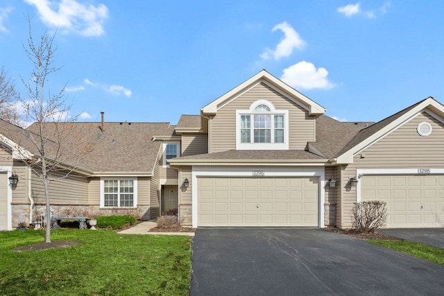 1296 Lake Shore Dr, Carol Stream, IL 60188 - view of front of home with aphalt driveway, stone siding, a front yard, a garage, and roof with shingles