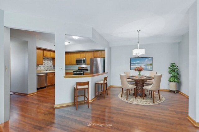 7841 W 157th St Unit 303, Orland Park, IL 60462 - dining area with dark wood-type flooring and baseboards