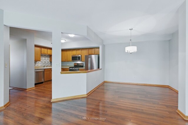 7841 W 157th St Unit 303, Orland Park, IL 60462 - kitchen with stainless steel appliances, brown cabinets, dark wood finished floors, and baseboards