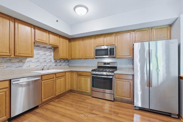 7841 W 157th St Unit 303, Orland Park, IL 60462 - kitchen featuring appliances with stainless steel finishes, a sink, and light countertops
