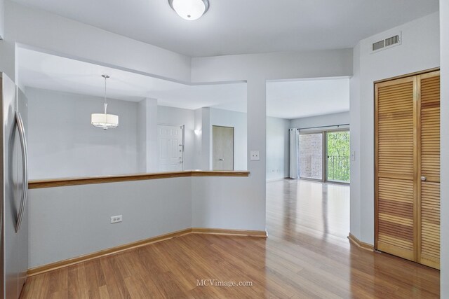 7841 W 157th St Unit 303, Orland Park, IL 60462 - spare room with wood finished floors and baseboards