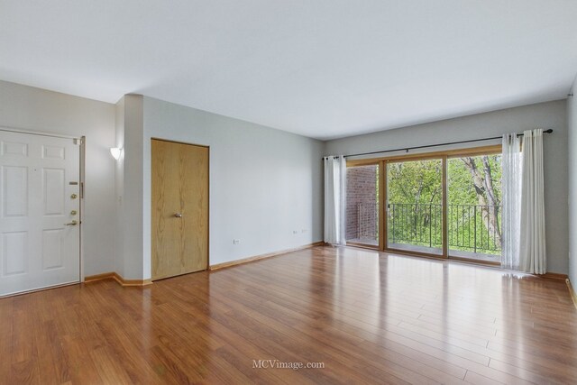 7841 W 157th St Unit 303, Orland Park, IL 60462 - unfurnished room with wood finished floors and baseboards