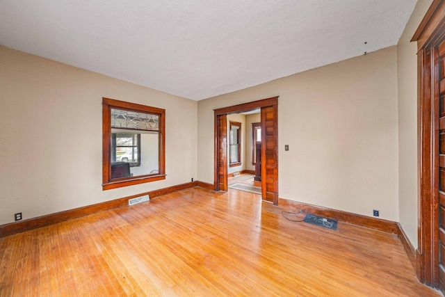 2523 Woods St, West Brooklyn, IL 61378 - spare room featuring light wood-type flooring, baseboards, and visible vents