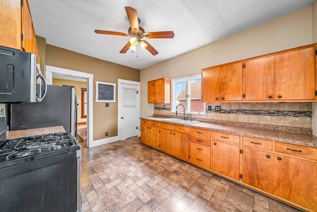 2523 Woods St, West Brooklyn, IL 61378 - kitchen featuring backsplash, appliances with stainless steel finishes, ceiling fan, and a sink