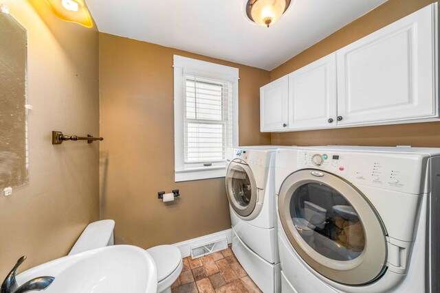 2523 Woods St, West Brooklyn, IL 61378 - washroom with stone finish floor, baseboards, a sink, and washer and clothes dryer